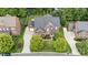 A bird's-eye view of a brick house, showcasing its manicured lawn, driveway, and surrounding trees at 16109 Reynolds Dr, Indian Land, SC 29707