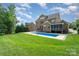 A lush green backyard features an in-ground pool and spacious lawn at 16109 Reynolds Dr, Indian Land, SC 29707