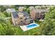 A beautiful backyard featuring a private pool, a patio with outdoor furniture, and a well-maintained lawn surrounded by trees at 16109 Reynolds Dr, Indian Land, SC 29707