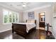 Inviting bedroom with hardwood floors, plantation shutters, and access to an ensuite bathroom at 16109 Reynolds Dr, Indian Land, SC 29707