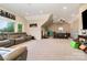 The bonus room has a plush gray sofa, lots of space, and recessed lights at 16109 Reynolds Dr, Indian Land, SC 29707