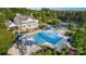 Aerial view of the community pool, clubhouse, waterslides, kiddie area, lounge chairs, and beautiful landscaping at 16109 Reynolds Dr, Indian Land, SC 29707