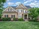 Charming two-story brick home featuring a lush green lawn and mature landscaping at 16109 Reynolds Dr, Indian Land, SC 29707
