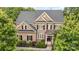 Aerial front view of a two-story brick home with a dark roof and mature trees surrounding the property at 16109 Reynolds Dr, Indian Land, SC 29707
