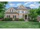 Charming two-story brick home with a well-manicured lawn and beautiful landscaping at 16109 Reynolds Dr, Indian Land, SC 29707