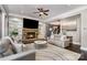 Bright living room showcasing a stone fireplace, built-in shelves, and neutral furniture at 16109 Reynolds Dr, Indian Land, SC 29707