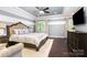 Relaxing primary bedroom featuring a tray ceiling and large windows at 16109 Reynolds Dr, Indian Land, SC 29707