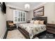 Cozy bedroom featuring a large window, chandelier, and decorative accents at 16109 Reynolds Dr, Indian Land, SC 29707