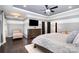 Serene primary bedroom showcasing tray ceiling, dark wood floors, and ample closet space at 16109 Reynolds Dr, Indian Land, SC 29707