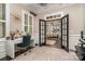 Bright home office with custom desk and chair, and doors leading into the dining area at 16109 Reynolds Dr, Indian Land, SC 29707