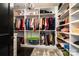 Spacious walk-in closet with custom shelving, ample storage, and a stylish chandelier at 16109 Reynolds Dr, Indian Land, SC 29707