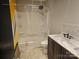 Well-lit bathroom with a shower-tub combo, modern vanity, and decorative marble countertop at 1700 Old Towne Ct, Charlotte, NC 28217