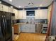 Bright kitchen featuring white cabinets, granite countertops, and stainless steel appliances at 1700 Old Towne Ct, Charlotte, NC 28217