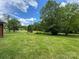 Expansive backyard with lush green grass and mature trees, providing privacy at 175 Triplett Rd, Cleveland, NC 27013