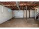 Unfinished basement with a garage door, offering ample space for storage or customization at 175 Triplett Rd, Cleveland, NC 27013