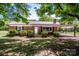 Charming brick home featuring a covered carport, mature trees, and a well-maintained lawn at 175 Triplett Rd, Cleveland, NC 27013