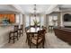 Elegant dining room with a chandelier, large window, and hardwood table perfect for Gathering dinners and entertaining at 18846 Cloverstone Cir, Cornelius, NC 28031