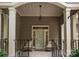 Cozy front porch with seating and a decorative light fixture at 18846 Cloverstone Cir, Cornelius, NC 28031