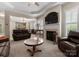 Spacious living room features a fireplace, ceiling fan, and open access to dining area at 18846 Cloverstone Cir, Cornelius, NC 28031
