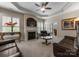 Inviting living room featuring a cozy fireplace, ceiling fan, and access to a sliding glass door at 18846 Cloverstone Cir, Cornelius, NC 28031