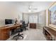 Well-lit office with two desks, multiple monitors, ample natural light, and comfortable seating at 18846 Cloverstone Cir, Cornelius, NC 28031