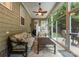Bright sunroom with neutral walls, tile floors, comfortable seating, and access to an outdoor patio at 18846 Cloverstone Cir, Cornelius, NC 28031