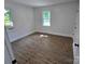 Bedroom featuring wood flooring, light walls, and natural light at 1900 Walkup Ave # 1, Monroe, NC 28110