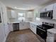 Bright kitchen featuring white cabinets, stainless steel appliances and wood flooring at 1900 Walkup Ave # 1, Monroe, NC 28110