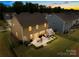 Beautiful backyard with patio featuring outdoor seating, a grill, and lush green grass surrounded by a black fence at 191 Tackle Box Dr, Troutman, NC 28166