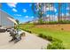 Spacious backyard with patio, comfortable seating, and tall, mature trees at 191 Tackle Box Dr, Troutman, NC 28166