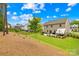 A serene backyard featuring a well-maintained lawn, patio seating, and a charming tree at 191 Tackle Box Dr, Troutman, NC 28166