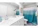 Bright bathroom featuring dual sinks, white cabinets, and a shower with curtain at 191 Tackle Box Dr, Troutman, NC 28166