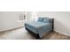 Comfortable bedroom with a blue bedspread, soft lighting, and neutral carpet at 191 Tackle Box Dr, Troutman, NC 28166