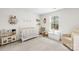 Cozy Bedroom with a crib, toy kitchen, decorations, and a comfortable armchair at 191 Tackle Box Dr, Troutman, NC 28166