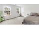Well-lit bedroom with two windows, neutral walls, and a cozy bed at 191 Tackle Box Dr, Troutman, NC 28166
