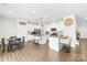 Spacious, modern kitchen with white cabinetry, stainless steel appliances, and a central island with bar seating at 191 Tackle Box Dr, Troutman, NC 28166