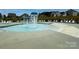 A community pool with playful water features, lounge chairs, and spacious deck area at 191 Tackle Box Dr, Troutman, NC 28166