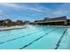 A large swimming pool with lap lanes, surrounded by lounge chairs and community buildings at 191 Tackle Box Dr, Troutman, NC 28166
