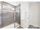 Tiled shower with glass door and shower head, includes soap niche and window at 191 Tackle Box Dr, Troutman, NC 28166