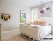 Charming bedroom with plush bedding, unique floral artwork, and soft natural lighting for a relaxing space at 19329 Youngblood W Rd # 4, Charlotte, NC 28278