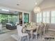 Bright dining room with a modern chandelier, large windows, and seamless access to an outdoor patio at 19329 Youngblood W Rd # 4, Charlotte, NC 28278