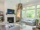 Cozy living room featuring a fireplace, large windows, and stylish furniture with natural light at 19329 Youngblood W Rd # 4, Charlotte, NC 28278