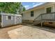 The backyard featuring a storage shed with a metal roof and concrete patio at 201 Easy St, Concord, NC 28027