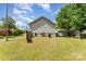 A spacious backyard with a well-maintained lawn, wooden fence, and storage shed for outdoor activities at 201 Easy St, Concord, NC 28027