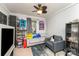 Eclectic bedroom with decorative items, a couch, a gray chair, and a ceiling fan at 201 Easy St, Concord, NC 28027