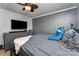 Cozy bedroom featuring a bed, dresser, mounted TV, and a side table at 201 Easy St, Concord, NC 28027
