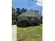Charming single-story home with a cozy front porch and well-maintained lawn and manicured shrubbery at 201 Easy St, Concord, NC 28027