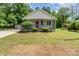 Charming single-story home with a welcoming porch, red front door, and well-maintained front yard at 201 Easy St, Concord, NC 28027