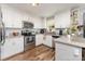 Bright kitchen featuring stainless steel appliances, granite countertops, and white cabinetry at 201 Easy St, Concord, NC 28027
