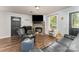 Cozy living room featuring hard wood floors, neutral-toned walls, and a fireplace with brick hearth at 201 Easy St, Concord, NC 28027